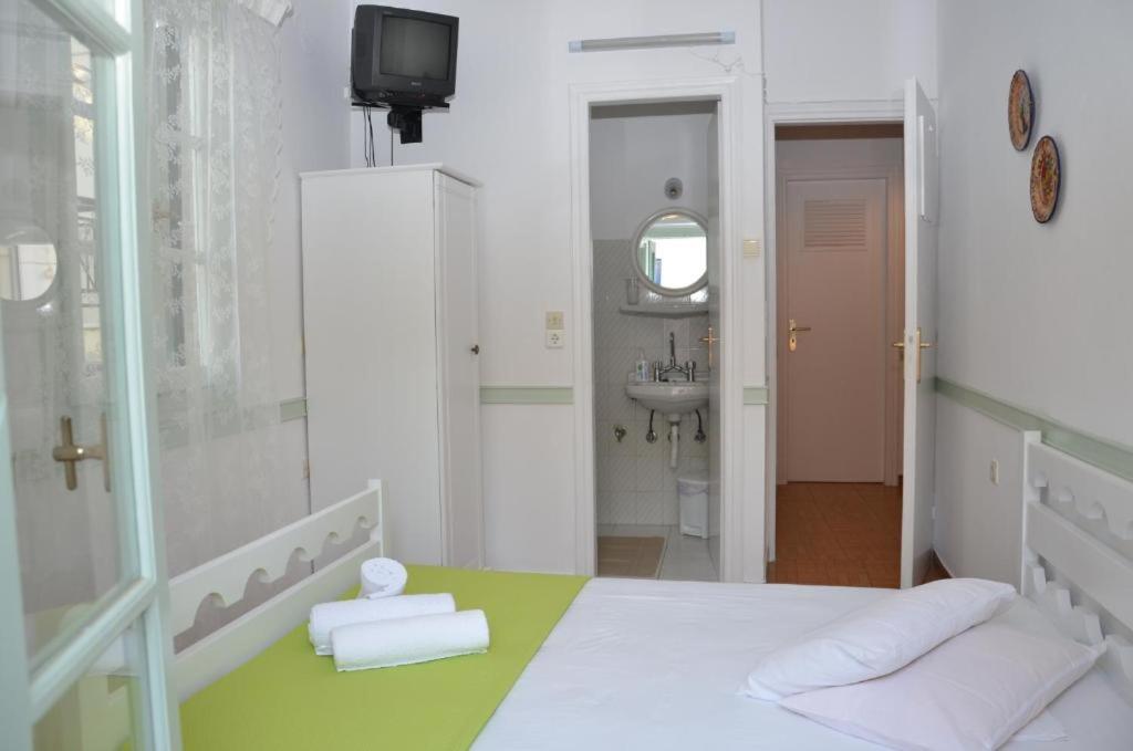 Postel nebo postele na pokoji v ubytování Aegli Rooms