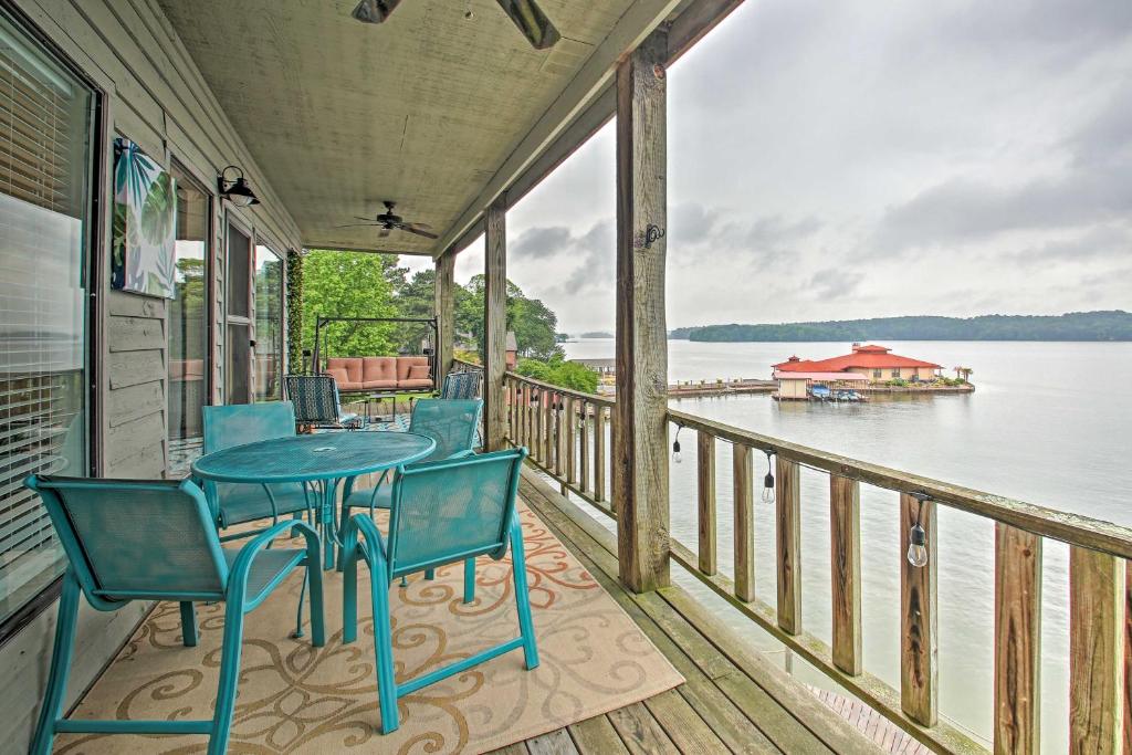 een veranda met een tafel en stoelen en uitzicht op het water bij Spacious Penthouse with Stunning Lakefront Views! in Hot Springs