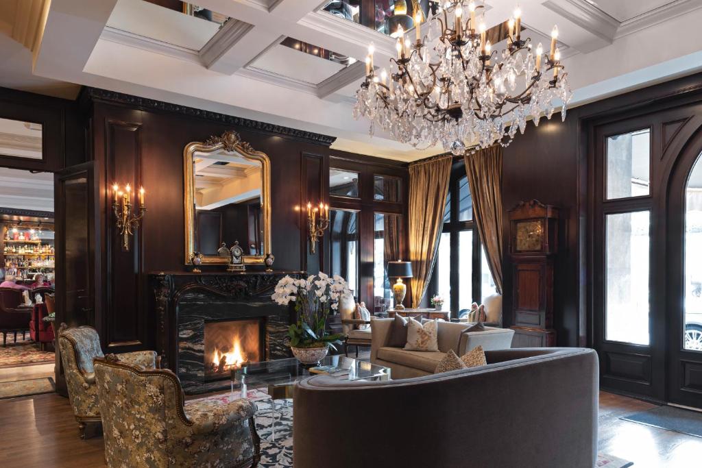 a living room with a fireplace and a chandelier at Wedgewood Hotel & Spa - Relais & Chateaux in Vancouver