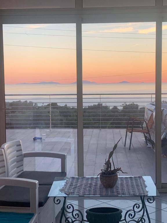 a living room with a view of the ocean at Hotel Royal in Coccorino