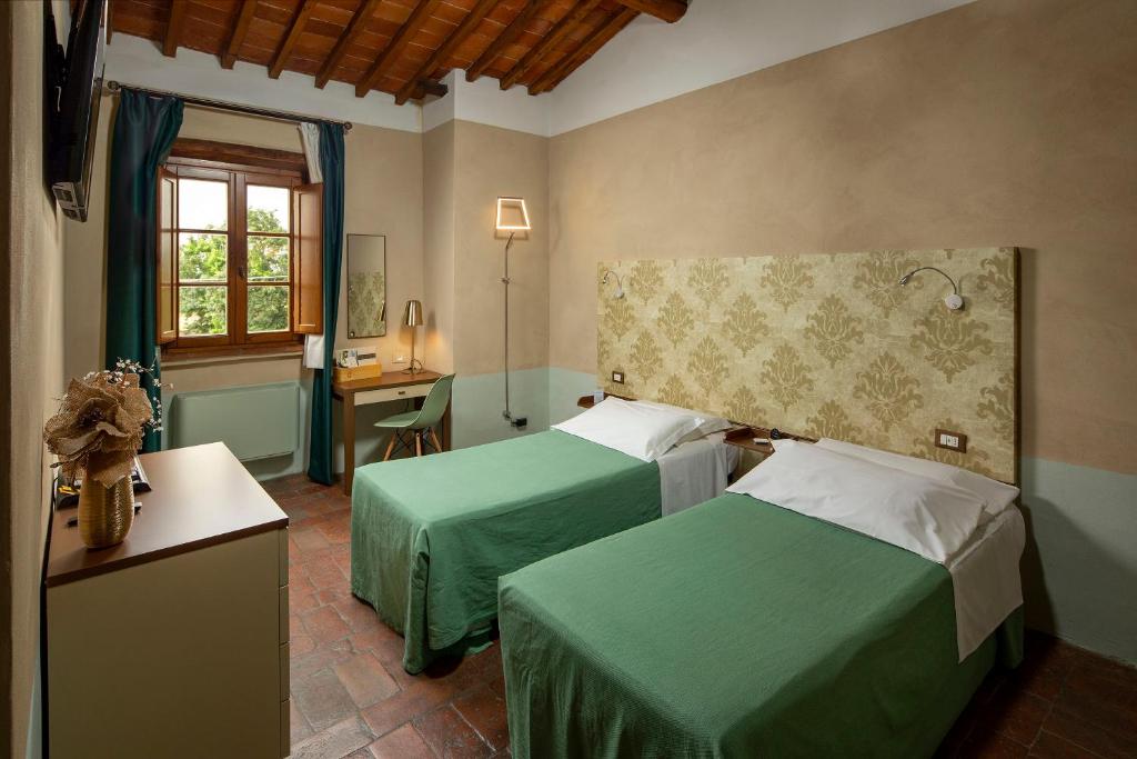 Postel nebo postele na pokoji v ubytování Hotel Le Capanne