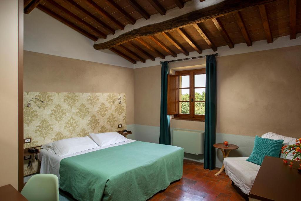 Postel nebo postele na pokoji v ubytování Hotel Le Capanne