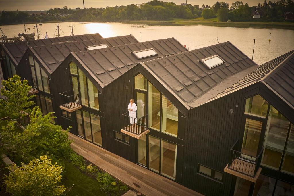 an overhead view of a house with a woman standing on a balcony at Netzschuppen in Kappeln