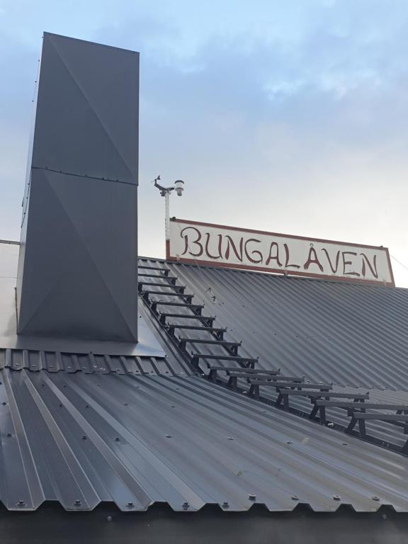 a metal roof with a sign on top of it at Bungalåven Cottages & Rooms in Børselv