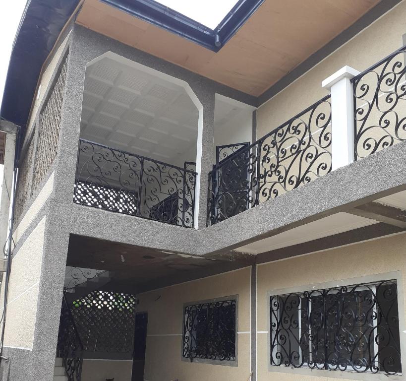 a balcony of a house with black iron railing at Résidence Sainte Honorine in Yaoundé