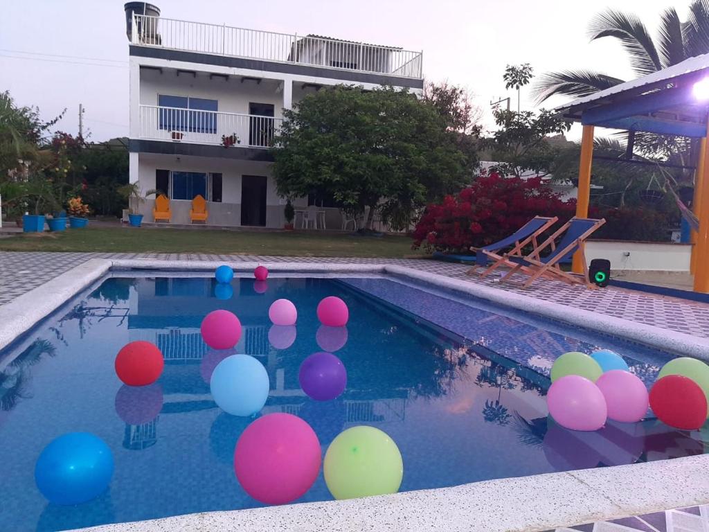 a swimming pool with colorful balls in the water at Casa de Campo Palmarito in Tubará
