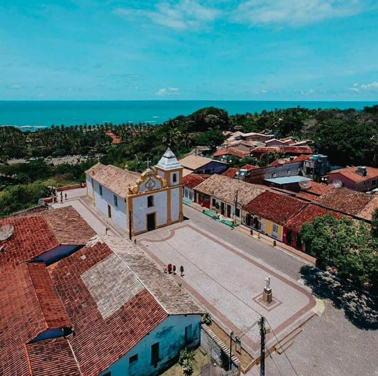 an aerial view of a town with a clock tower at Pousada Arraial Suites in Arraial d'Ajuda