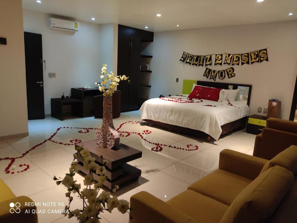 a bedroom with a bed and a living room at Hotel SanJo in San José Iturbide