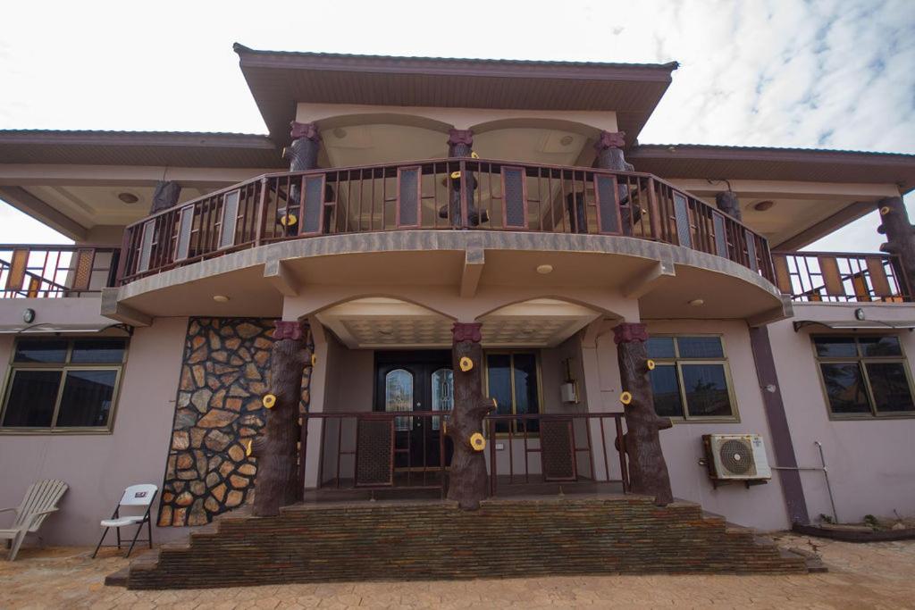 a large house with a balcony on top of it at Villadcoco in Nungua