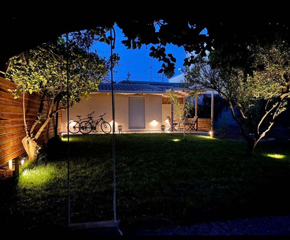 a backyard at night with lights in the grass at Green room in Marathopolis