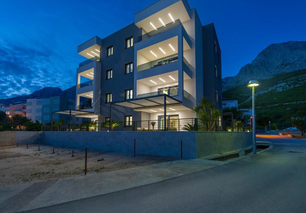 a large building with lights on in the night at Villa IN in Promajna