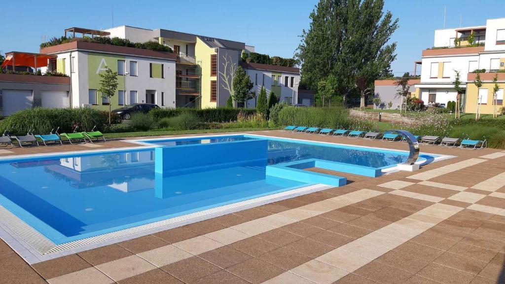 a swimming pool with blue water in a building at Apartment in Balatonalmadi 36663 in Balatonalmádi