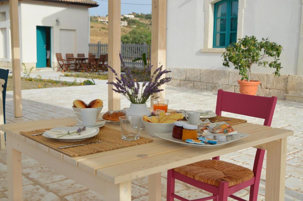 a wooden table with a plate of food on it at B&B Fermata 106 da Carolina in Siculiana Marina