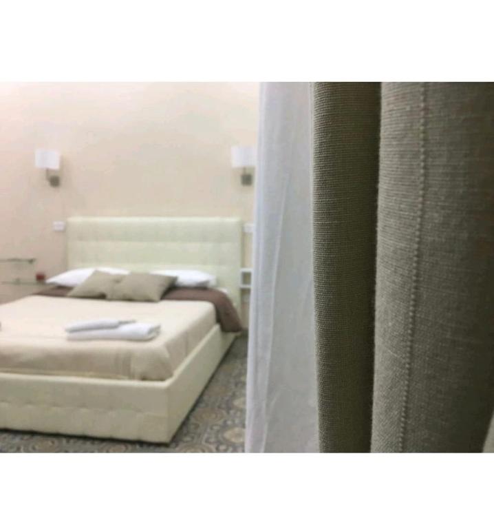 A bed or beds in a room at Decumani Prestige