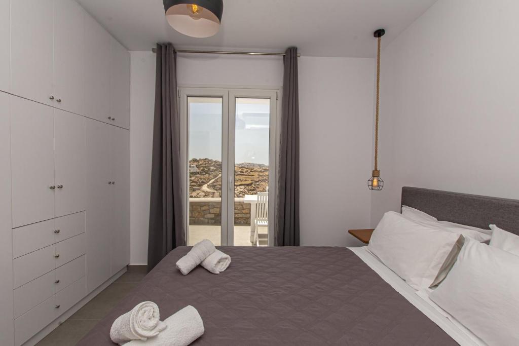 Postel nebo postele na pokoji v ubytování Lofos Apartments