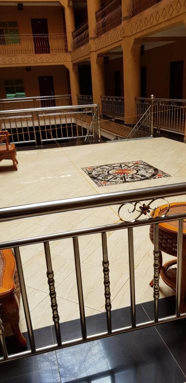 an empty stage in a building with a rug on the floor at Biraj International Hotel in Kampala