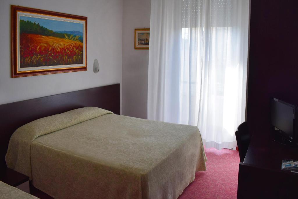 Postel nebo postele na pokoji v ubytování Hotel Igea Spiaggia