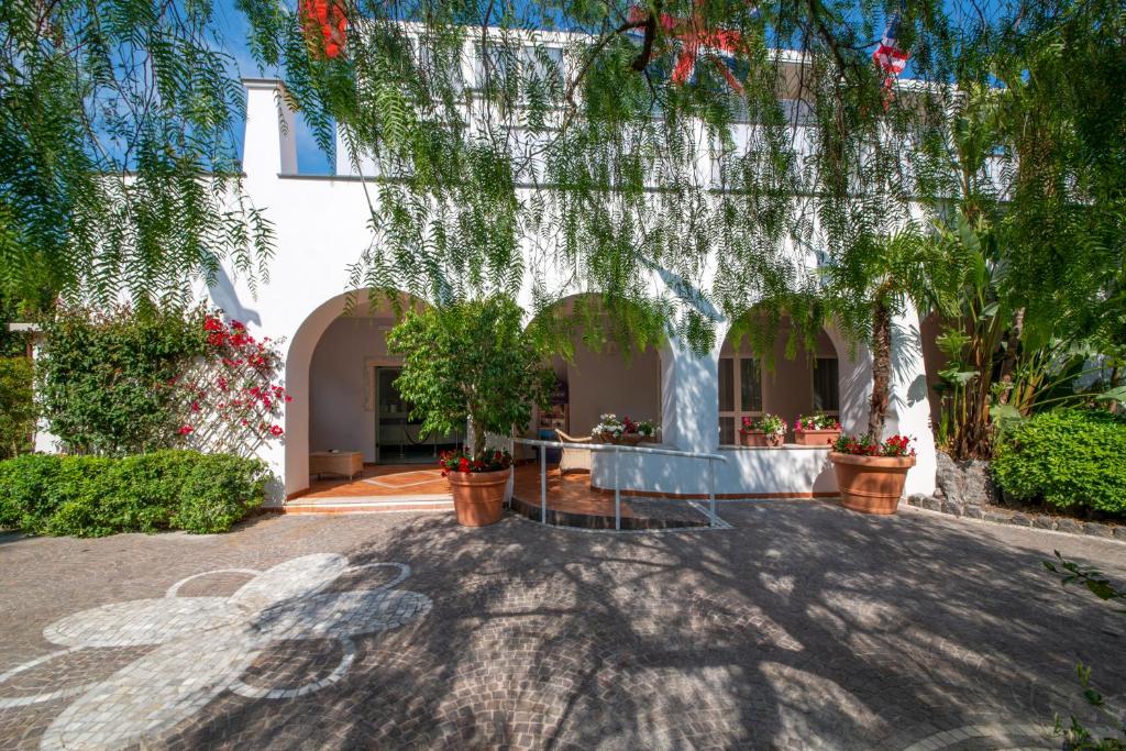 a house with trees and plants in a yard at Hotel Villa Durrueli Resort & Spa in Ischia