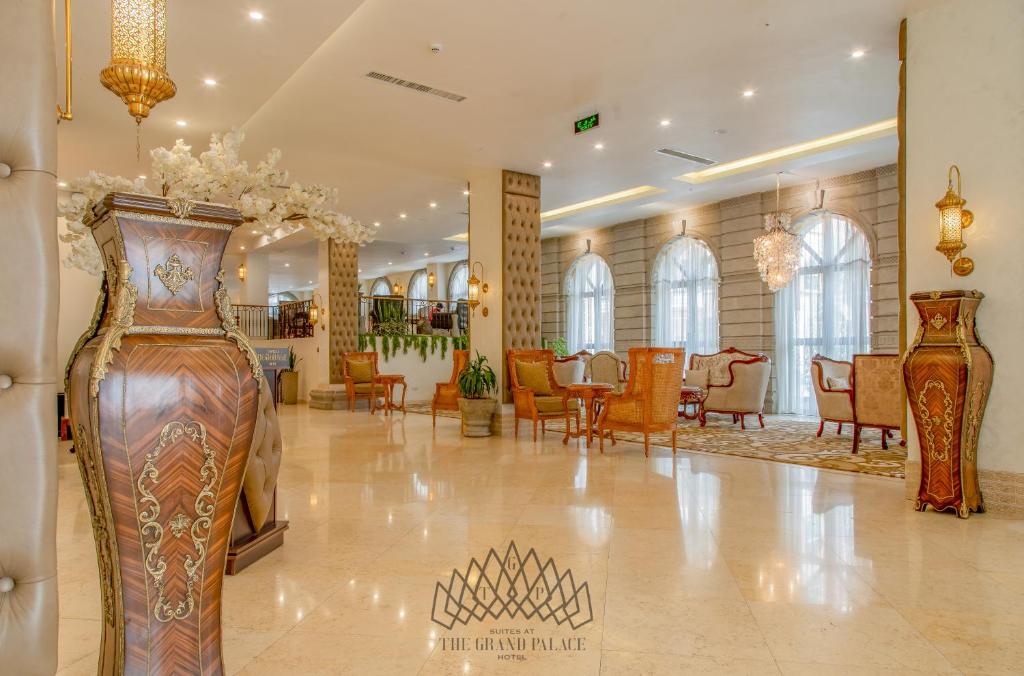 a lobby with two vases on the floor and chairs at The Grand Palace Hotel in Addis Ababa