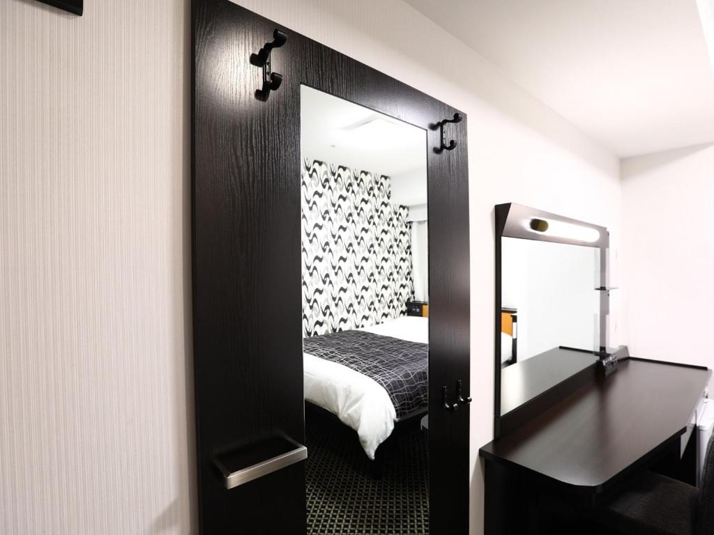 Postel nebo postele na pokoji v ubytování APA Hotel Nagano