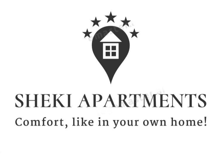 ein Schild, auf dem sich "Stick apartments comfort like in your own home" liest in der Unterkunft Sheki Apartments in Şəki