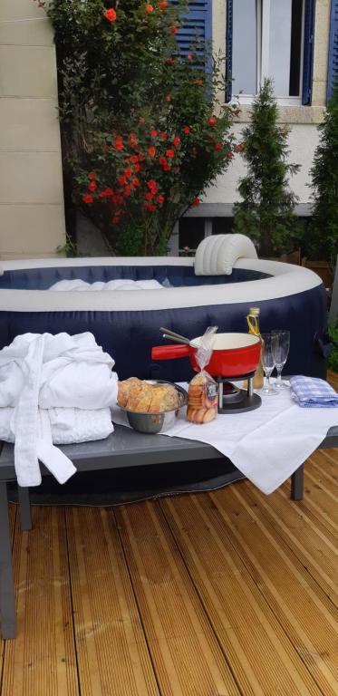 a table with a tray of food on top at Gîte La Fabrique , spa , bain nordique in Les Fontenelles