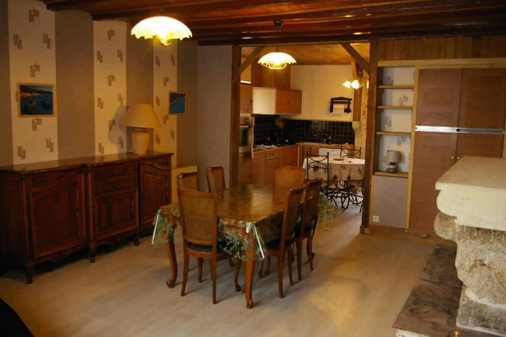 eine Küche und ein Esszimmer mit einem Tisch und Stühlen in der Unterkunft Gite au Chalet in Laferté-sur-Aube