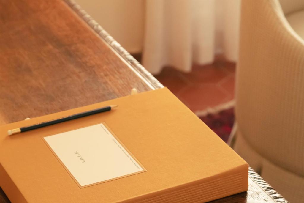 a box with a pen on top of a table at Hotel la Ponche in Saint-Tropez