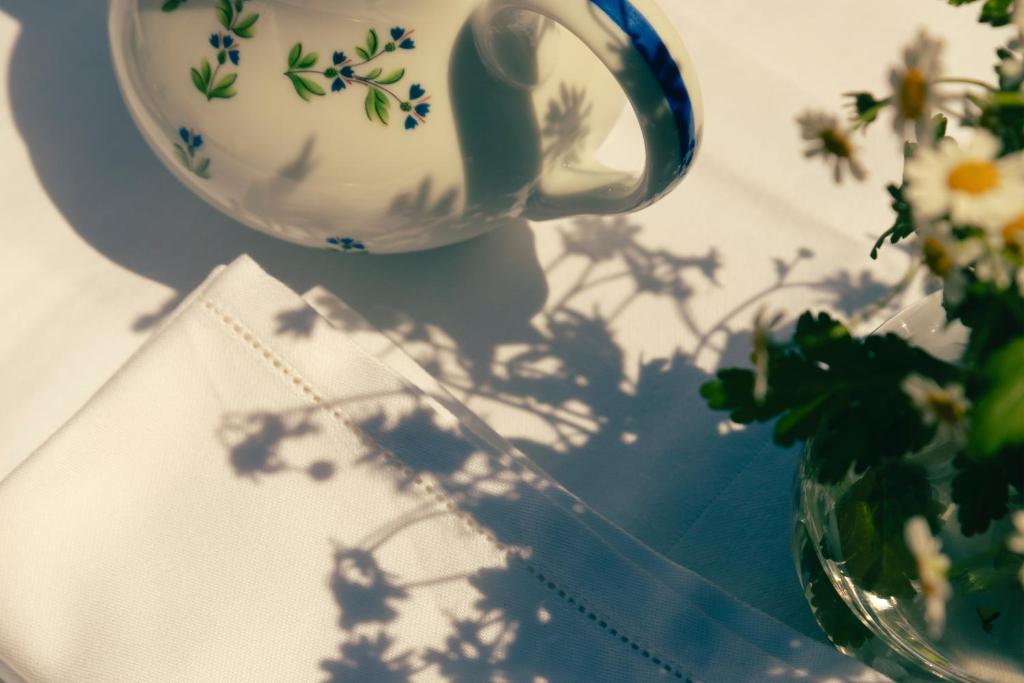 a vase with flowers is sitting next to a vase with a plant at Hotel la Ponche in Saint-Tropez
