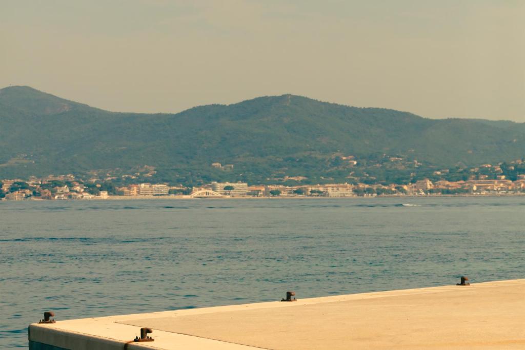a body of water with mountains in the background at Hotel la Ponche in Saint-Tropez