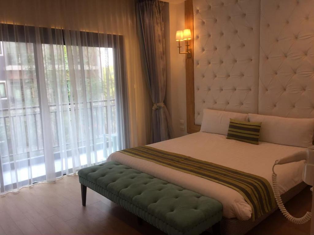 a bedroom with a large bed and a window at Zotel in Chiang Mai