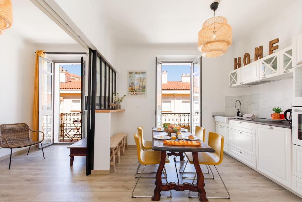 eine Küche und ein Esszimmer mit einem Tisch und Stühlen in der Unterkunft La Colline YourHostHelper in Cannes
