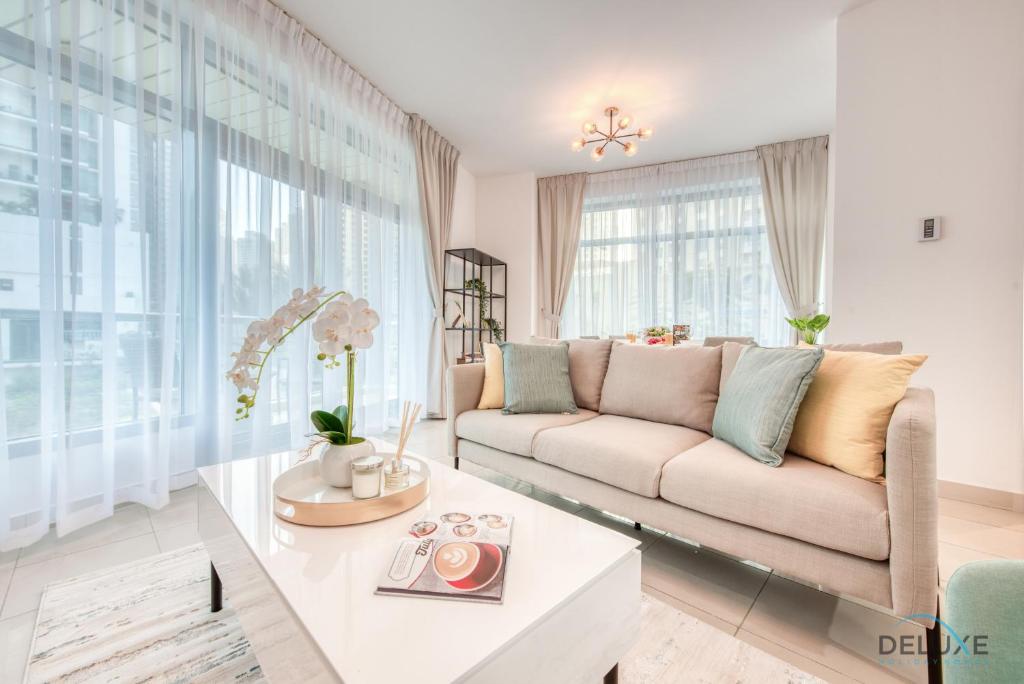 a living room with a couch and a table at Airy 1BR at Park Island Sanibel Dubai Marina by Deluxe Holiday Homes in Dubai