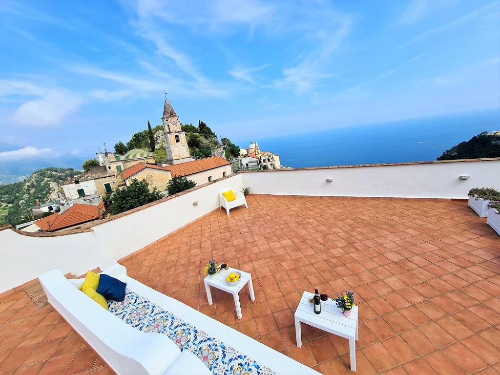 a balcony with two tables and a view of the ocean at La Casa Dei Venti in Amalfi