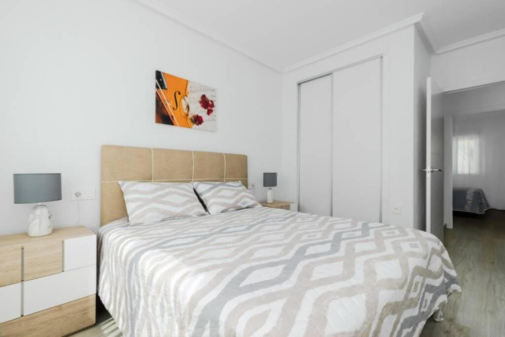 A bed or beds in a room at Apartment with pool TORREVISTA ROCIO