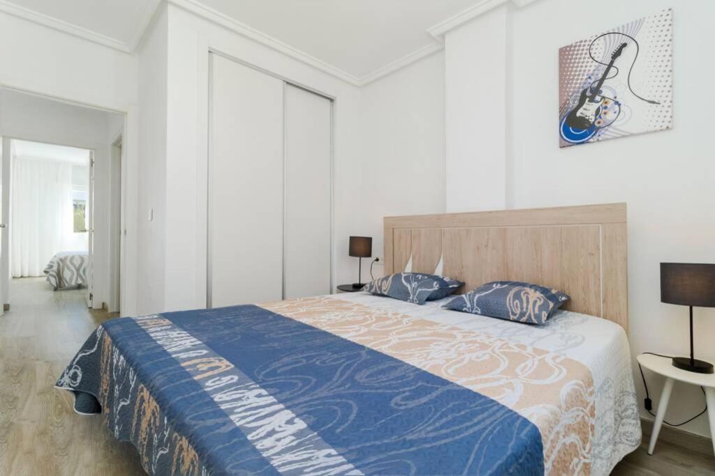 A bed or beds in a room at Apartment with pool TORREVISTA ROCIO