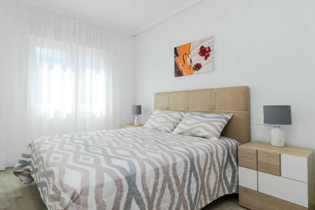 A bed or beds in a room at Apartment with pool TORREVISTA ROCIO