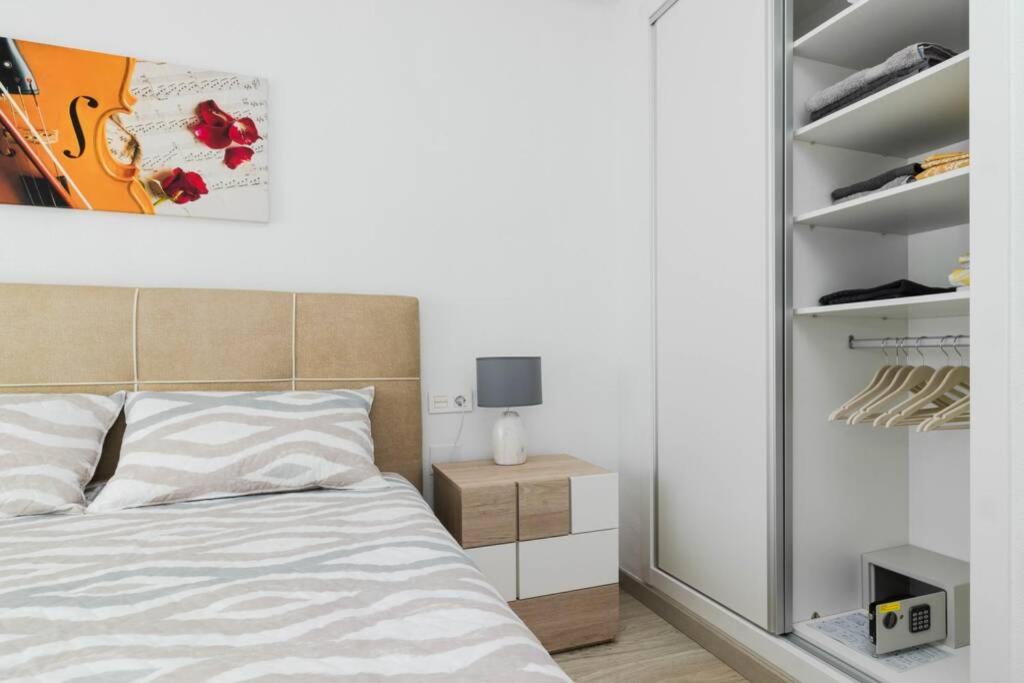 A bed or beds in a room at Apartment with pool TORREVISTA ROCIO
