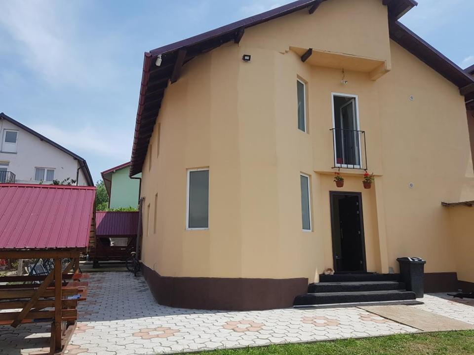 a large building with a black door and stairs on it at Casa Vlad in Costinesti
