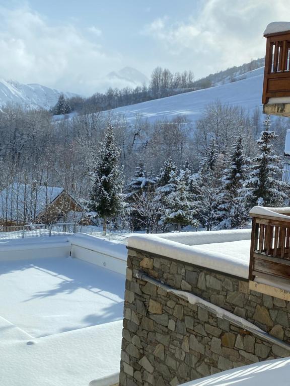 a swimming pool covered in snow next to a balcony at Logement 4&#47;6 personnes à la montagne avec piscine in Saint-Sorlin-dʼArves