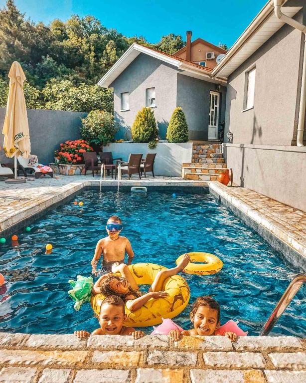 a group of children playing in a swimming pool at Studios Merdović in Budva