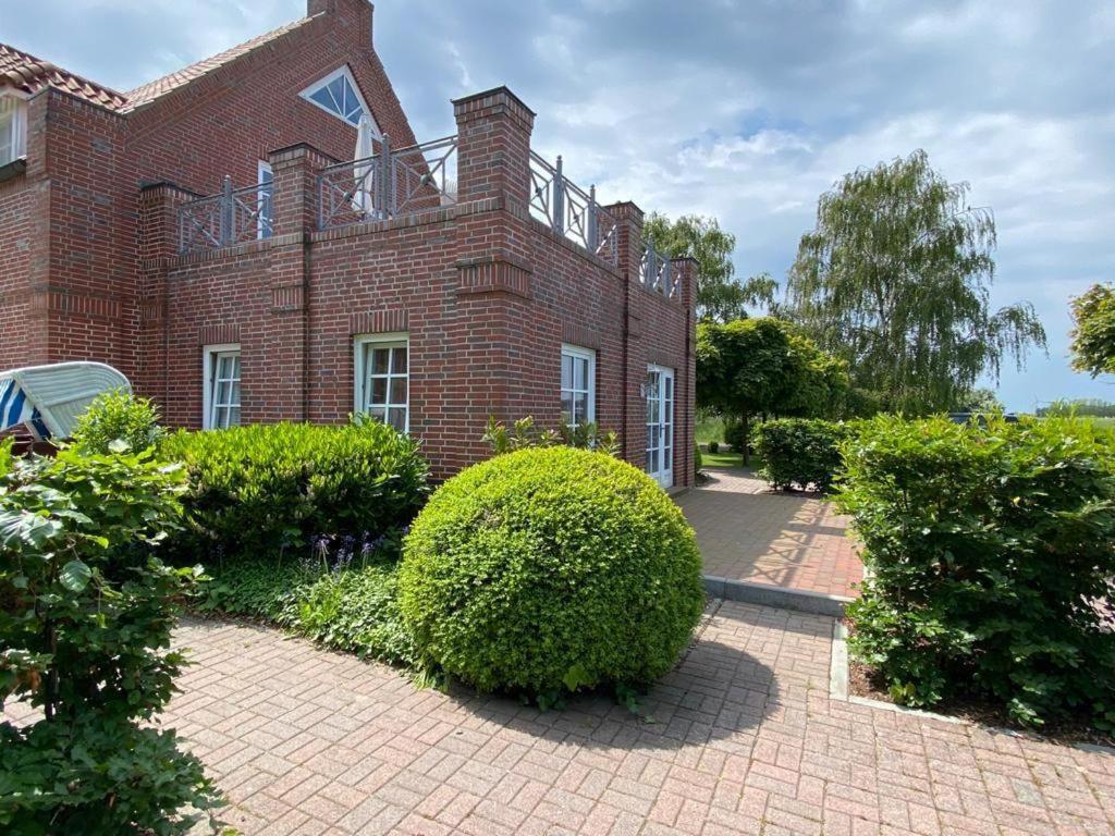 a large brick building with bushes in front of it at NTAB10105-FeWo-Moeoevwarder-fief in Neue Tiefe Fehmarn