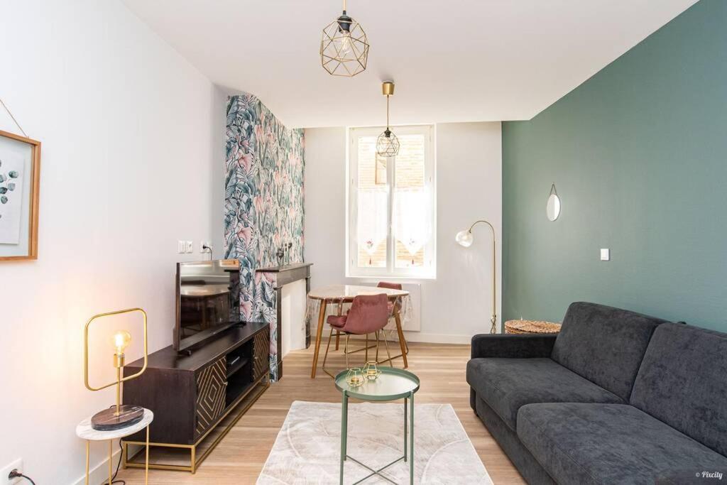 a living room with a couch and a table at ART & DECO - STUDIO COEUR DE VILLE in Agen
