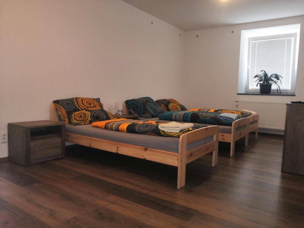 a room with two beds and a couch at U Moto Makovic in Horažďovice