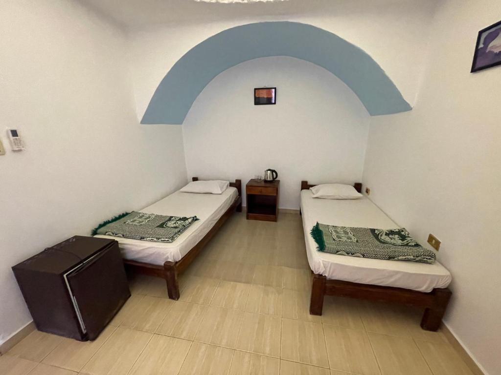 Postel nebo postele na pokoji v ubytování Dolphin Camp