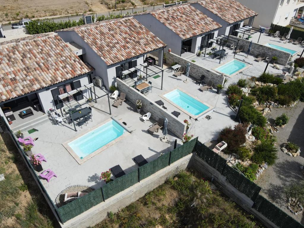 an aerial view of a house with two swimming pools at Le Domaine De Marie in Palasca