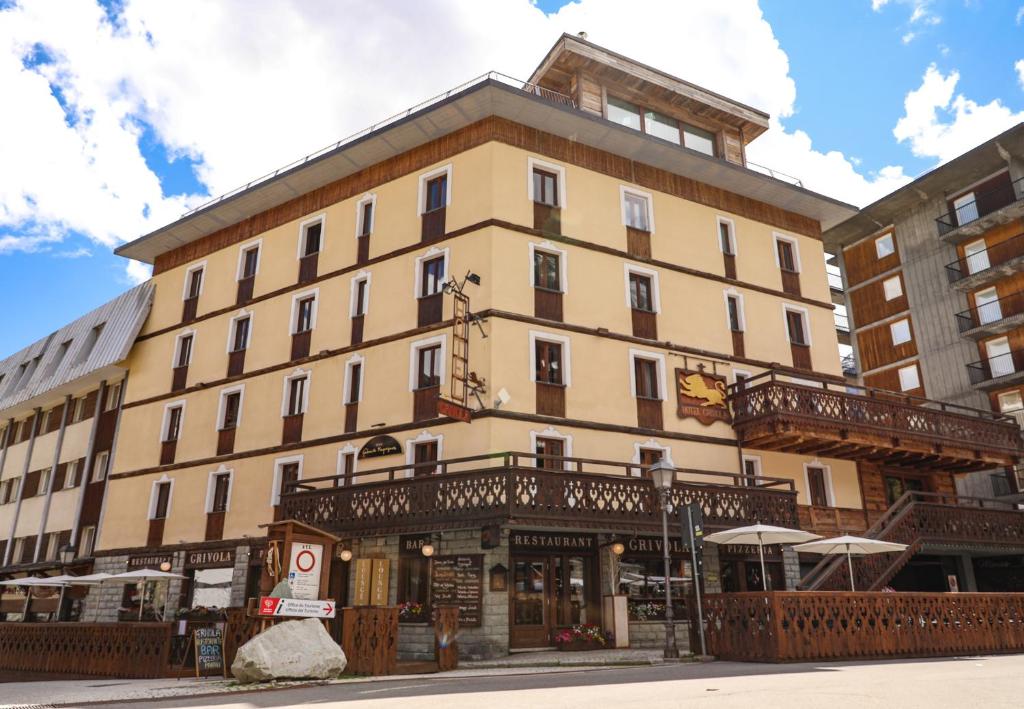 a large building on the corner of a street at Art Hotel Grivola in Breuil-Cervinia