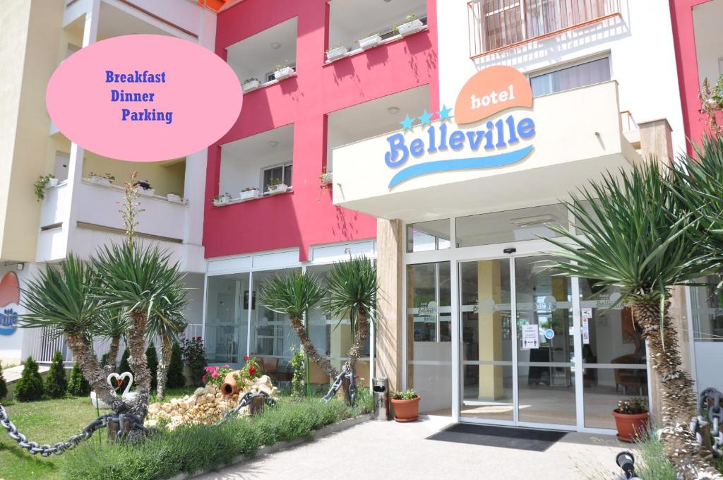 a building with palm trees in front of it at Hotel BelleVille in Sunny Beach