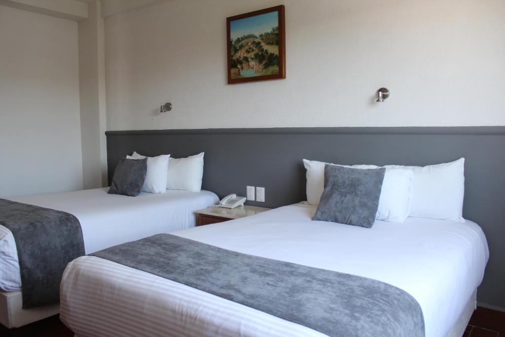 Postel nebo postele na pokoji v ubytování Hoteles Unico Express