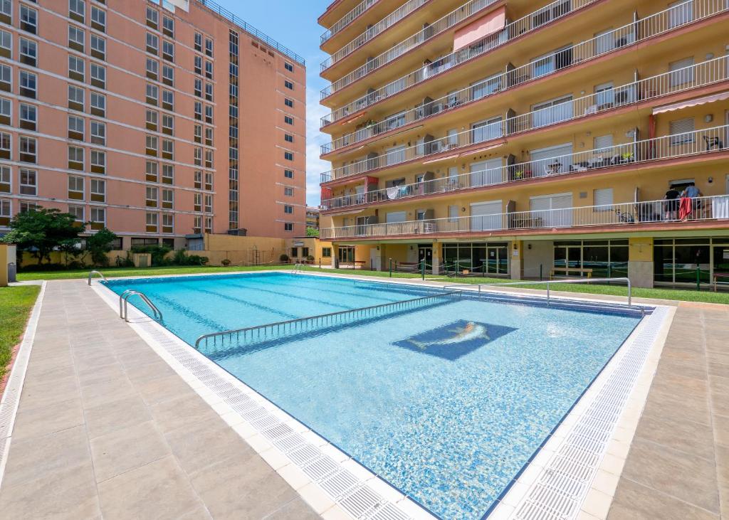 a large swimming pool in front of a building at HomeHolidaysRentals Bonte in Malgrat de Mar